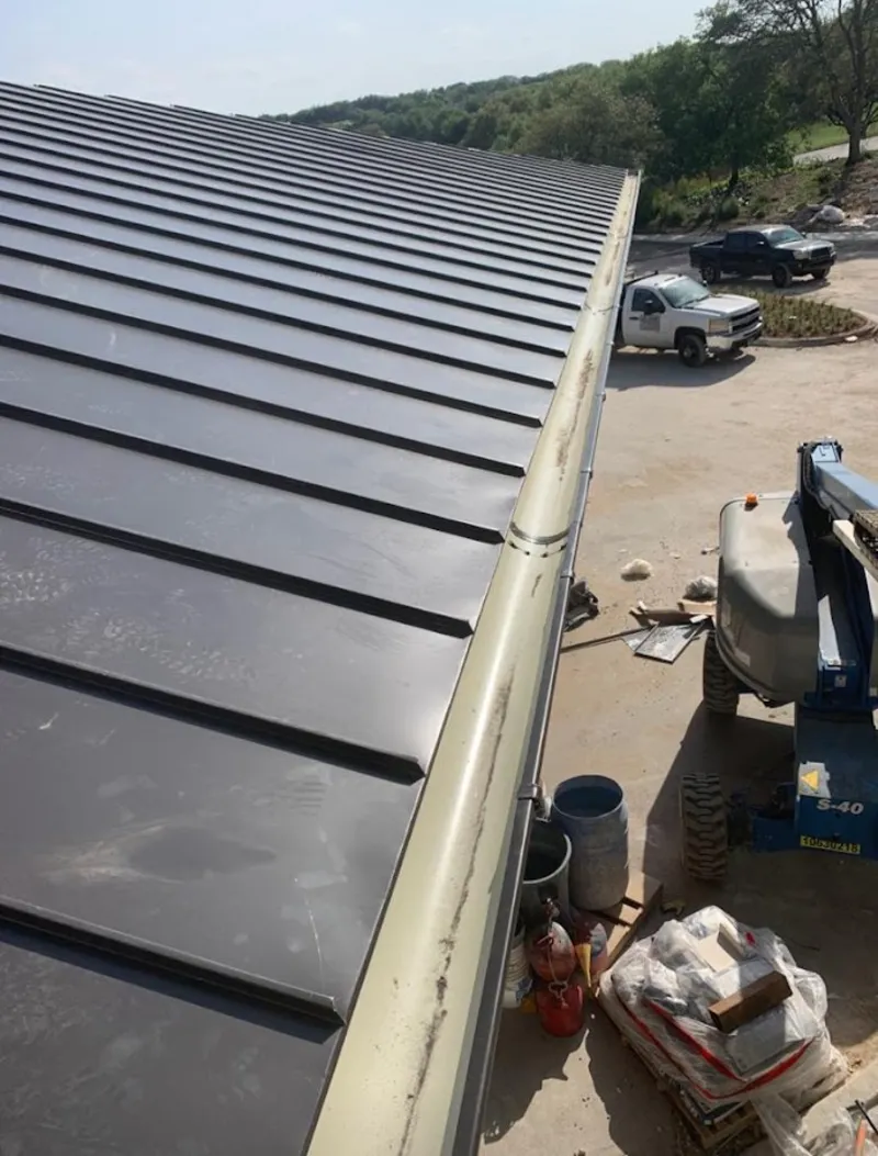 Standing seam panel and gutter detail on a metal roofing jobsite in Thompson's Station